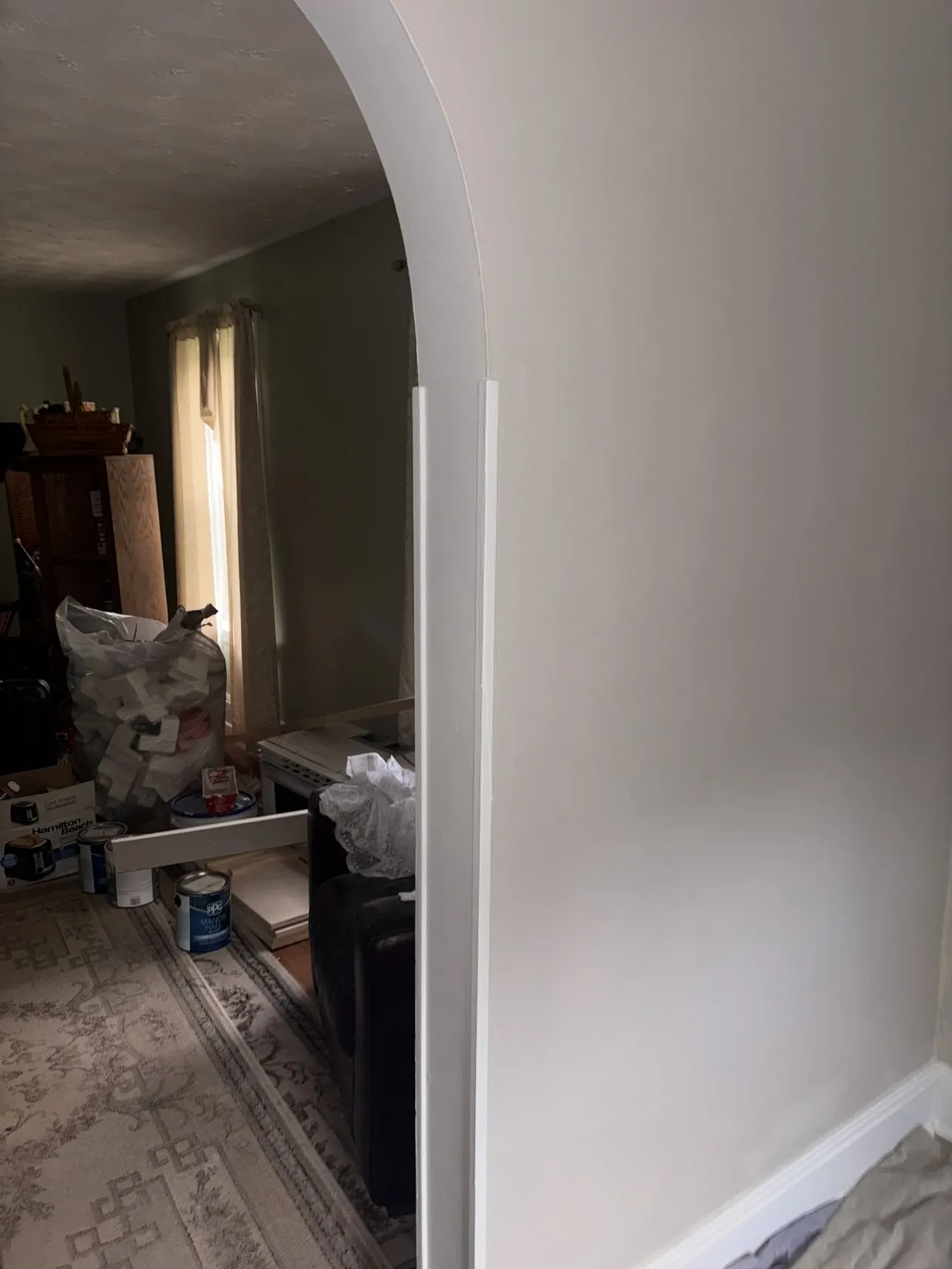 Smooth white arched doorway with fresh trim and a clean wall finish