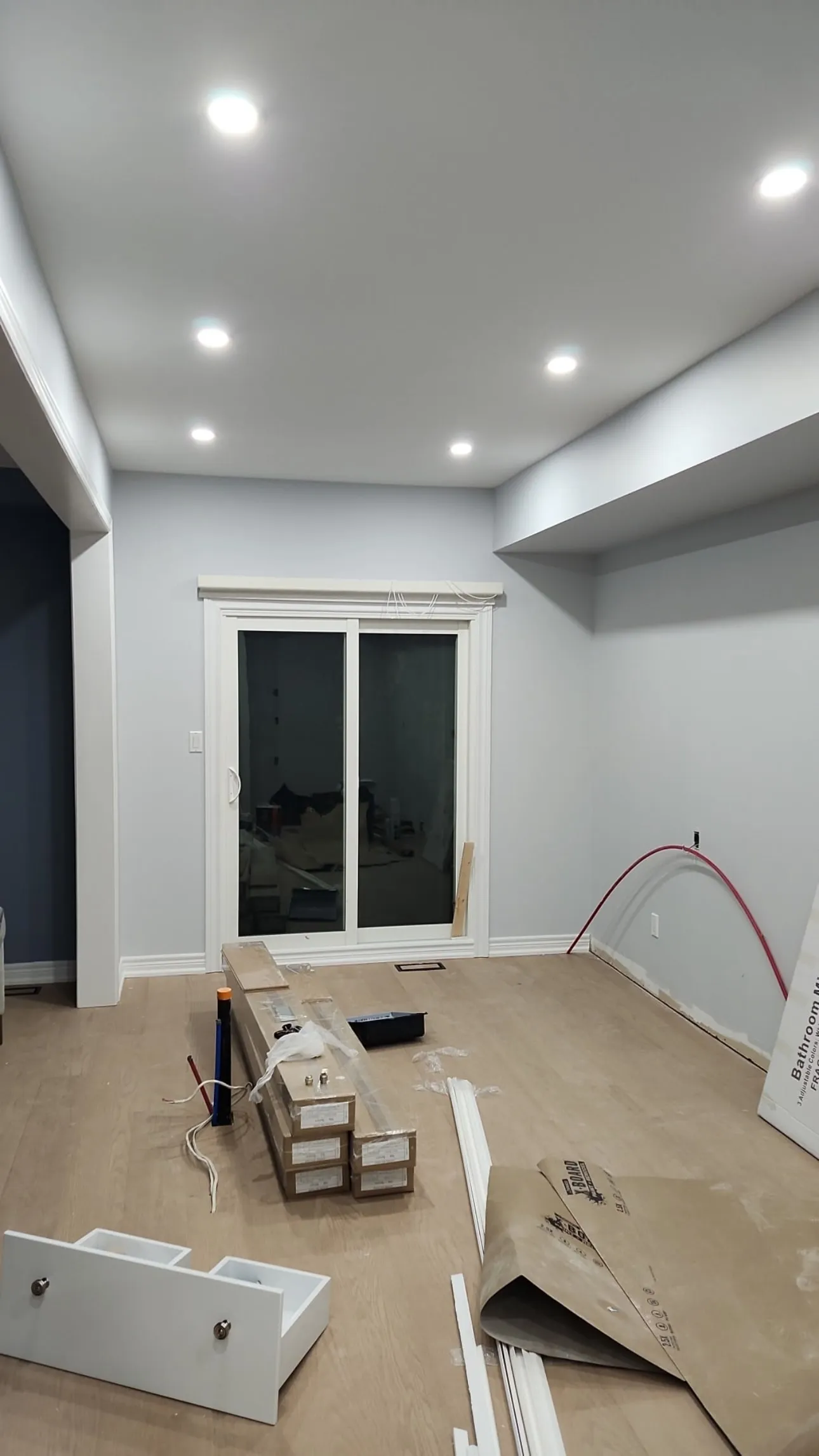 Family room with pale blue walls, white ceiling and trim around a sliding door
