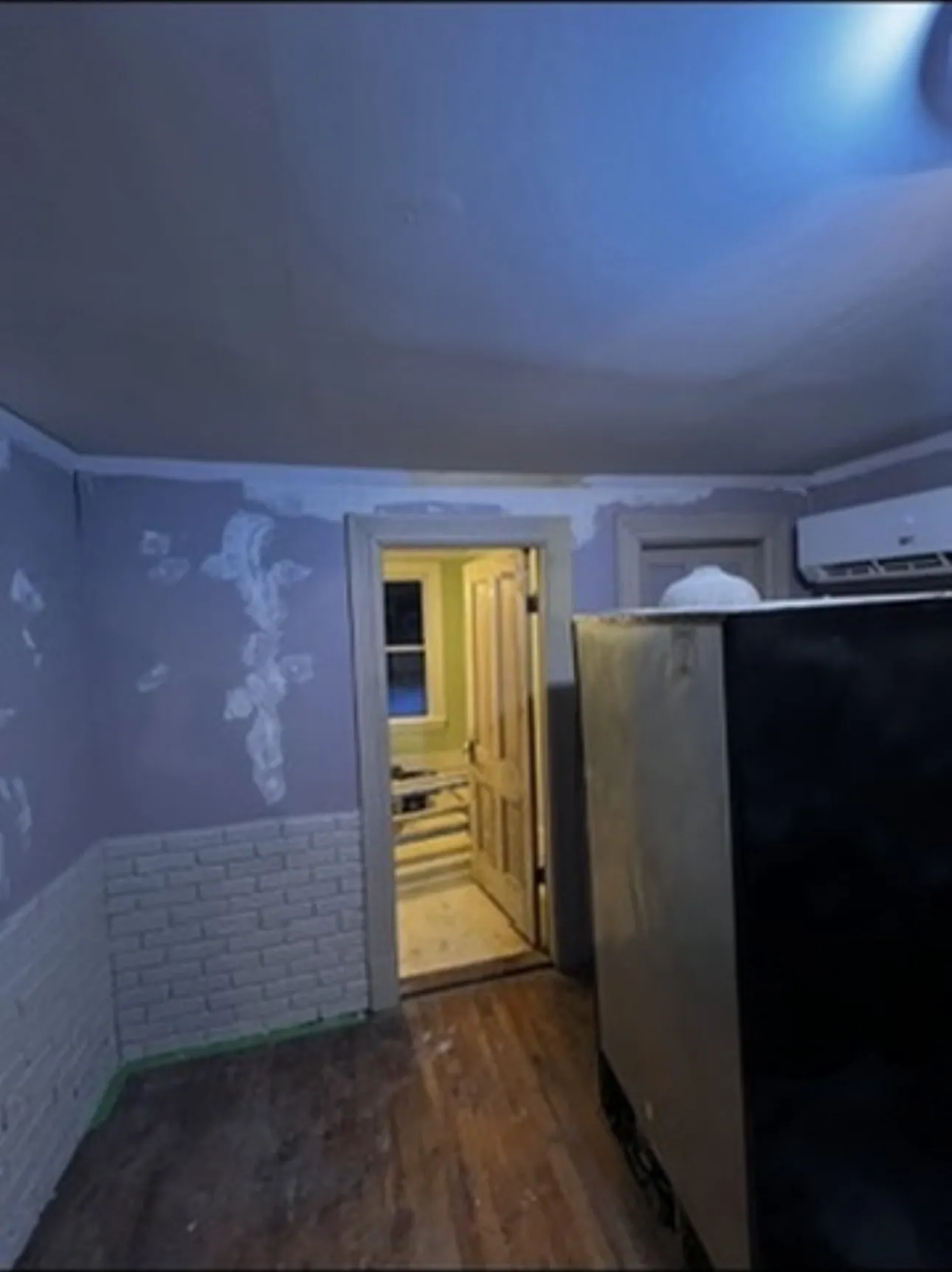 The same walls before painting, with plaster patches feathered and sanded smooth
